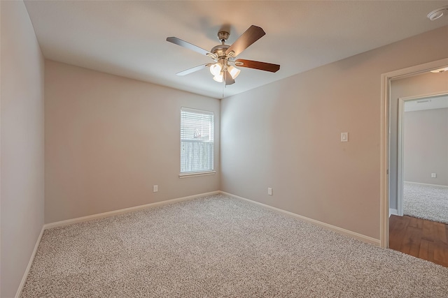 unfurnished room featuring carpet floors, baseboards, and a ceiling fan