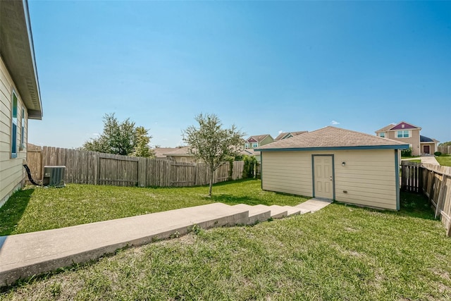 view of yard featuring an outbuilding, a fenced backyard, and central AC unit