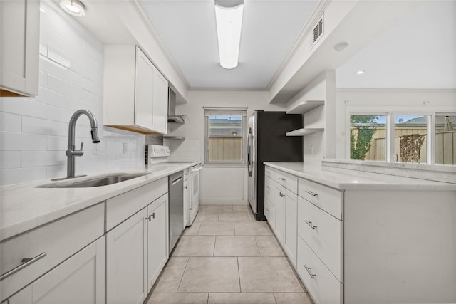 kitchen with appliances with stainless steel finishes, ornamental molding, white cabinetry, open shelves, and a sink