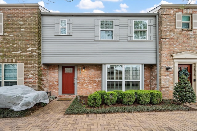 townhome / multi-family property with brick siding