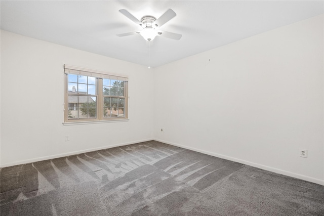 spare room with carpet, ceiling fan, and baseboards