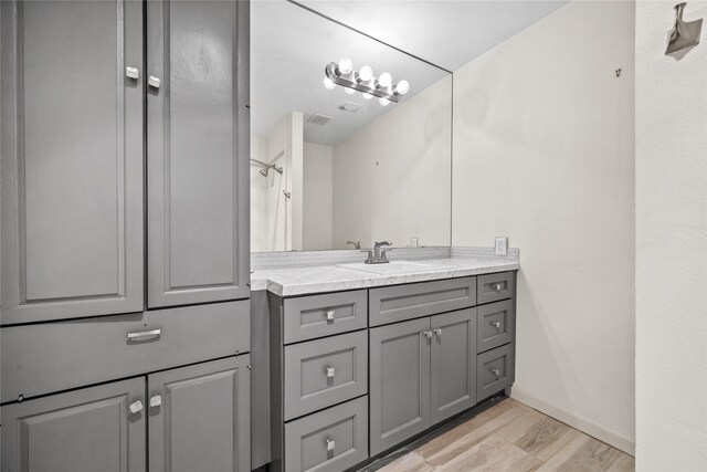 5874 Doliver Dr Unit 121, Houston, TX 77057 - bathroom with vanity and wood finished floors