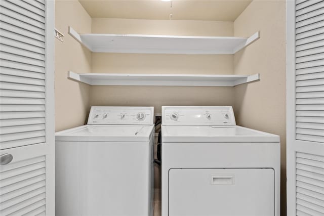 clothes washing area with laundry area and washer and clothes dryer