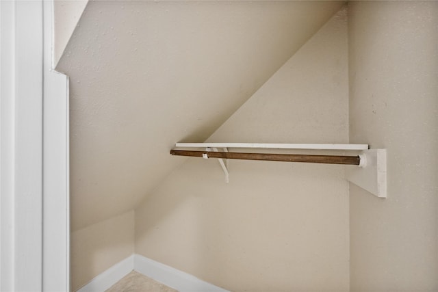 walk in closet featuring vaulted ceiling