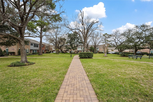 view of home's community featuring a residential view and a lawn