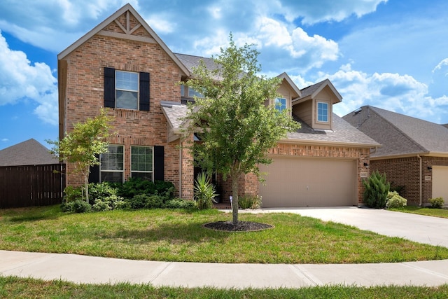 traditional-style house featuring a garage, concrete driveway, brick siding, and a front yard