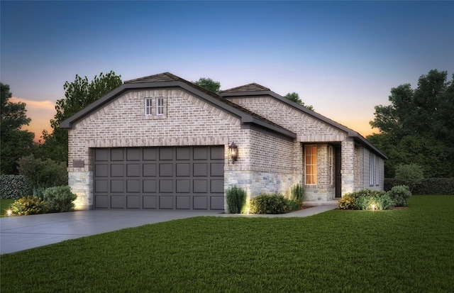 view of front of property featuring driveway, brick siding, stone siding, an attached garage, and a front yard