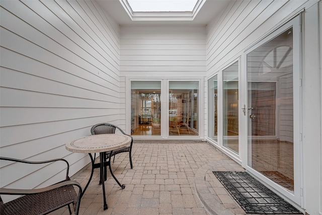 unfurnished sunroom featuring a skylight