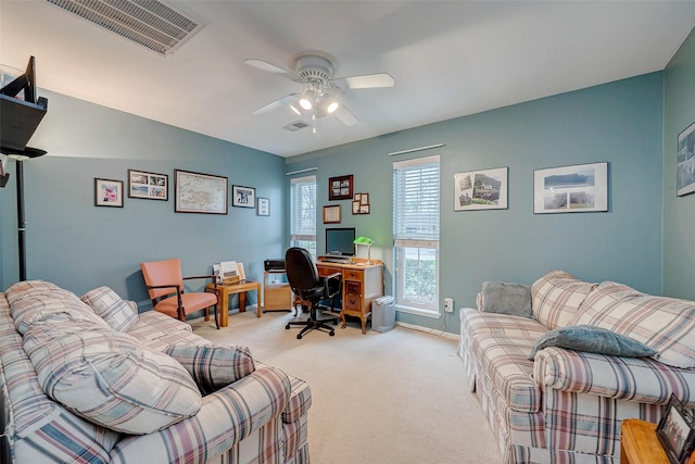 office space with light carpet, ceiling fan, visible vents, and baseboards