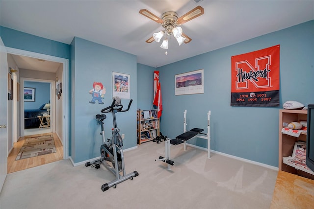 workout room with carpet floors, ceiling fan, and baseboards