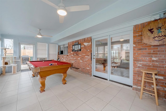 game room featuring light tile patterned floors, brick wall, ceiling fan, and billiards