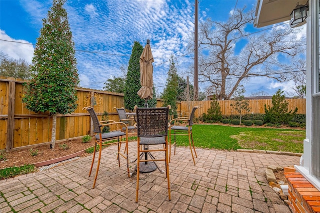 view of patio with a fenced backyard and outdoor dining space