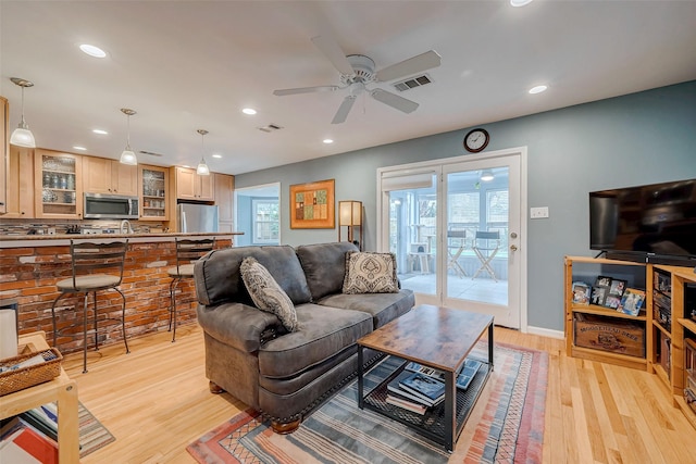 living room with a ceiling fan, recessed lighting, visible vents, and light wood-style floors