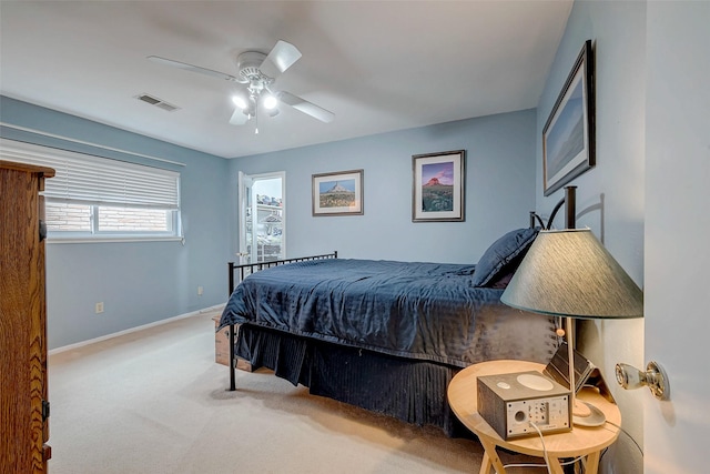 bedroom featuring light carpet, ceiling fan, visible vents, and baseboards