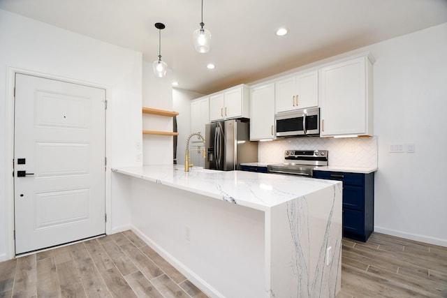 kitchen featuring white cabinets, appliances with stainless steel finishes, blue cabinets, a peninsula, and open shelves