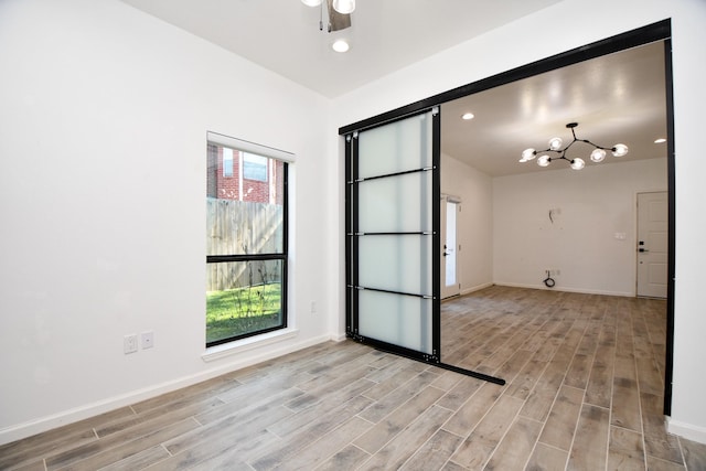 empty room featuring light wood-style floors, ceiling fan, baseboards, and recessed lighting