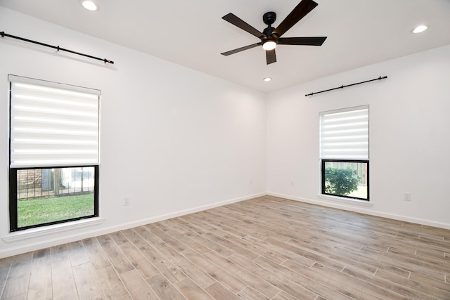 unfurnished room featuring light wood-style floors, baseboards, and recessed lighting