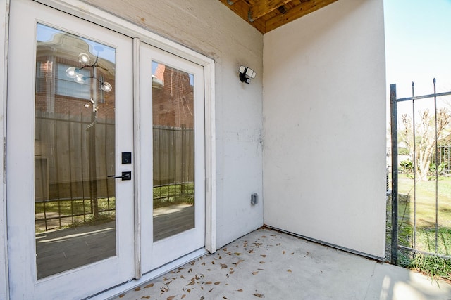 property entrance featuring french doors and stucco siding