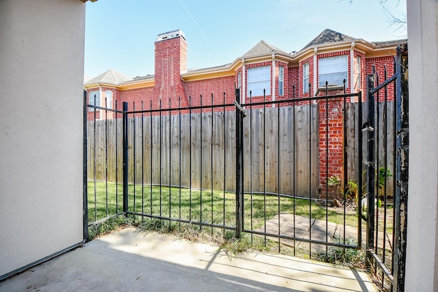 view of gate featuring fence