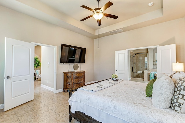 bedroom with light tile patterned floors, ceiling fan, visible vents, baseboards, and a tray ceiling