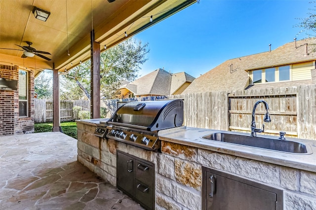 view of patio featuring area for grilling, ceiling fan, a fenced backyard, grilling area, and a sink