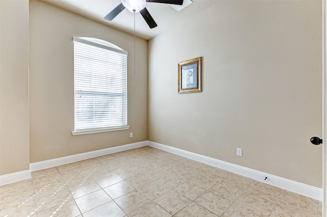 spare room with light tile patterned floors, ceiling fan, and baseboards