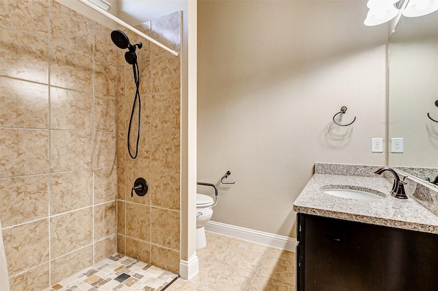 full bathroom featuring toilet, vanity, a shower stall, baseboards, and tile patterned floors