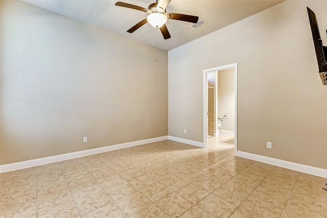 spare room featuring visible vents, ceiling fan, baseboards, and light tile patterned floors