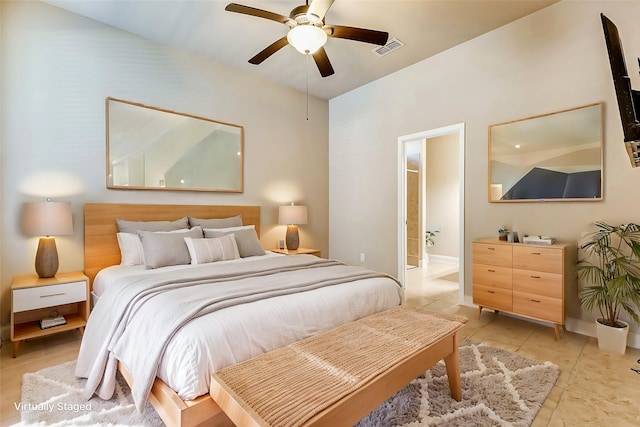 bedroom with light tile patterned floors, a ceiling fan, visible vents, baseboards, and ensuite bath