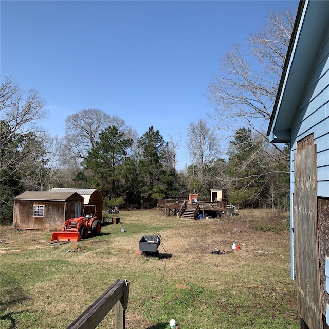 view of yard with an outdoor structure and a wooden deck