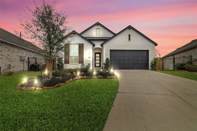 view of front facade featuring brick siding, fence, a garage, driveway, and a front lawn