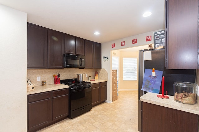 kitchen with light countertops, dark brown cabinetry, and black appliances