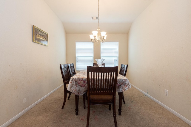 dining room with vaulted ceiling, baseboards, visible vents, and a notable chandelier