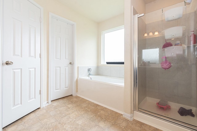 bathroom featuring a shower stall, baseboards, and a bath