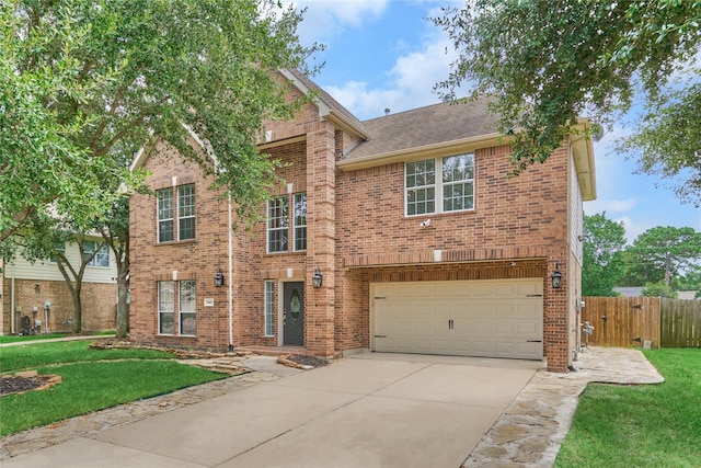 traditional-style house featuring an attached garage, a front lawn, concrete driveway, and brick siding