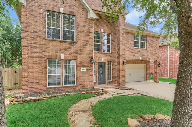 traditional-style house featuring driveway, a garage, fence, a front lawn, and brick siding