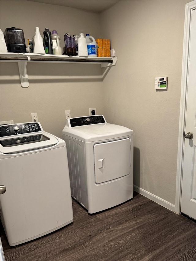 laundry area with washing machine and dryer, laundry area, baseboards, and dark wood-style flooring