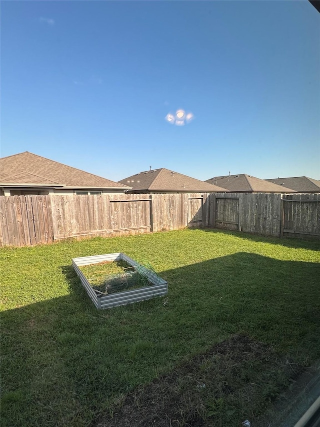 view of yard with a fenced backyard