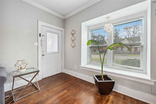 entrance foyer with baseboards, ornamental molding, dark wood finished floors, and a notable chandelier