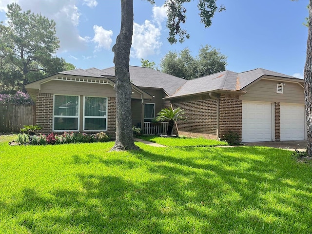 view of front facade featuring a garage, brick siding, a front lawn, and fence