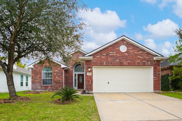 ranch-style home featuring a garage, driveway, brick siding, and a front yard