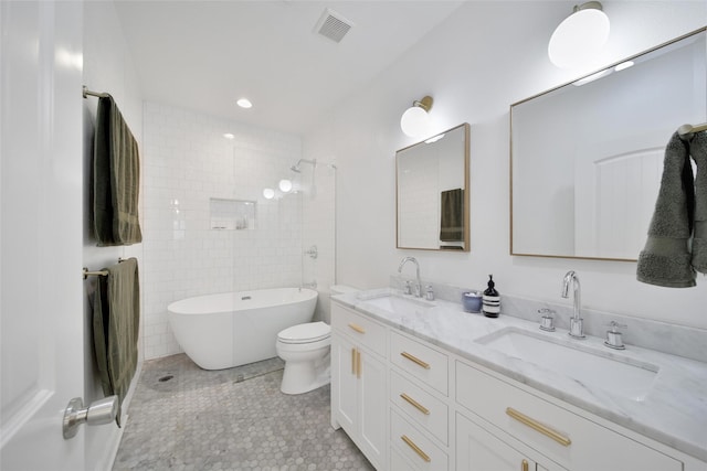 full bathroom with double vanity, a soaking tub, visible vents, and a sink