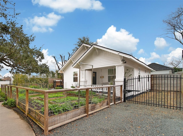 view of front of home featuring a garden and fence