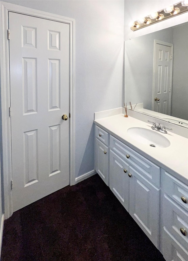 bathroom with vanity and baseboards