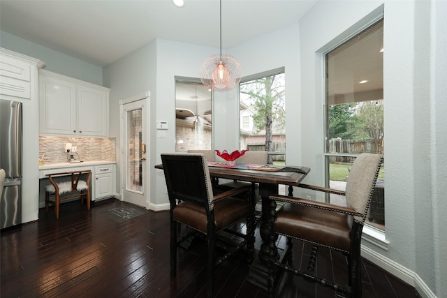 dining area featuring baseboards and dark wood-style flooring