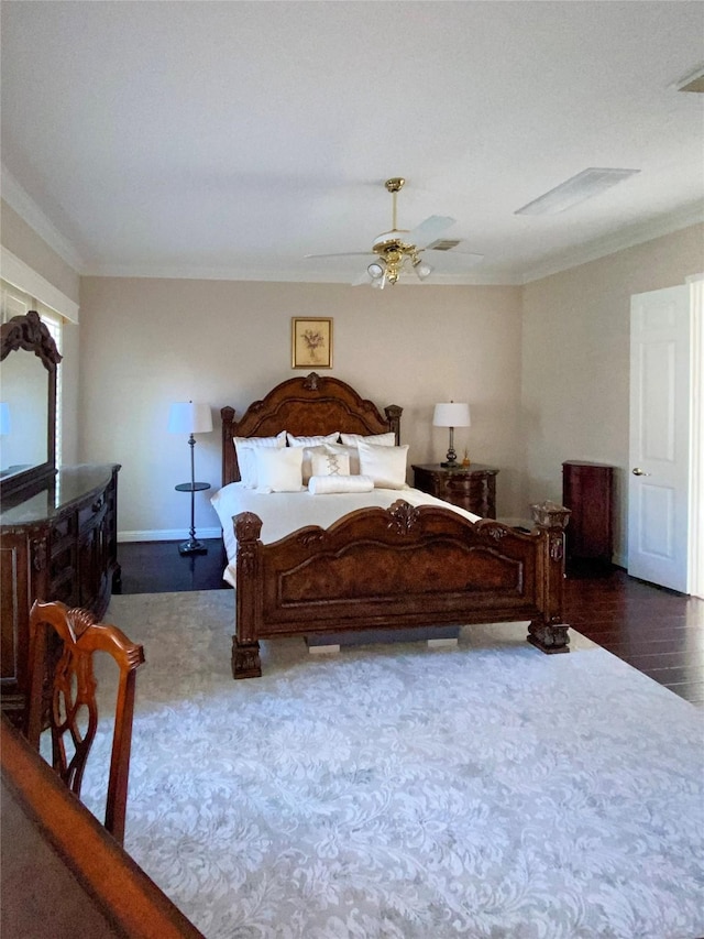 bedroom featuring ceiling fan, dark wood-type flooring, baseboards, and crown molding