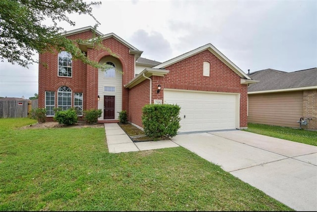 traditional-style house with driveway, brick siding, an attached garage, and a front yard