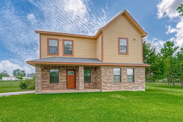 view of front facade featuring brick siding, a front lawn, and a shingled roof