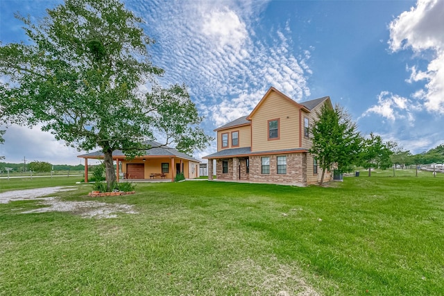 rear view of property featuring brick siding and a yard