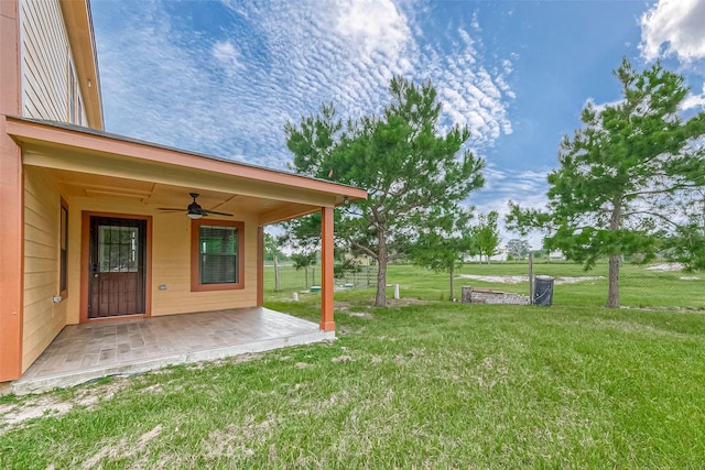 view of yard with a patio area, ceiling fan, and fence